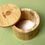 Thumbnail: Bamboo salt pot with lid slid open to show contents on a green background