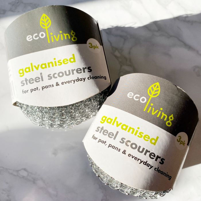 Two packs of galvanised steel scourers resting on a kitchen counter