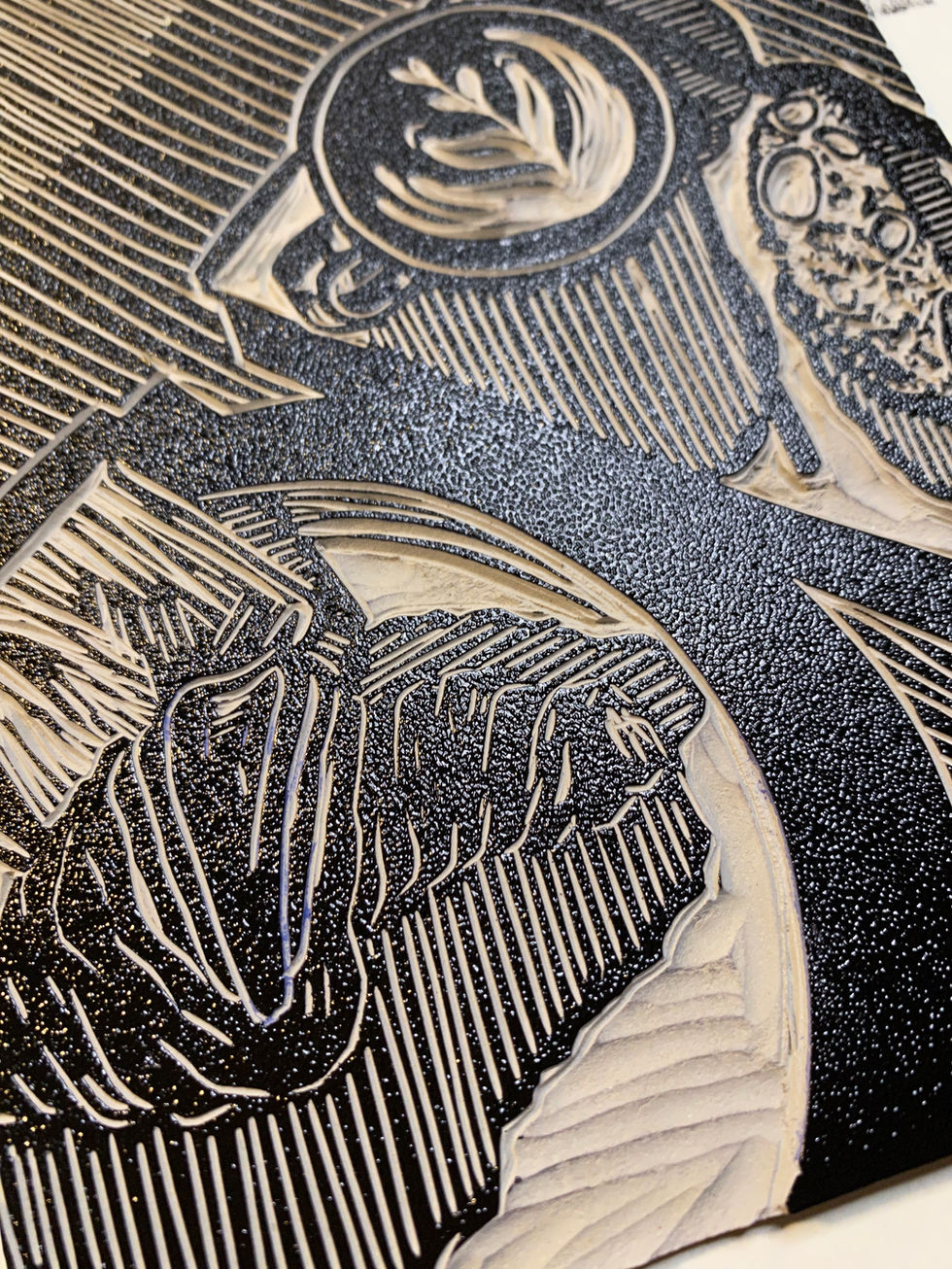 black linocut print of coffee and a croissant