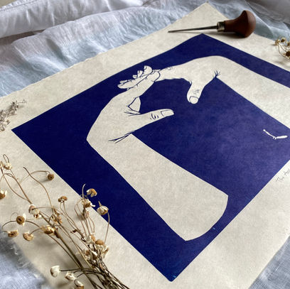 dark blue linocut print of two hands formed into an arch