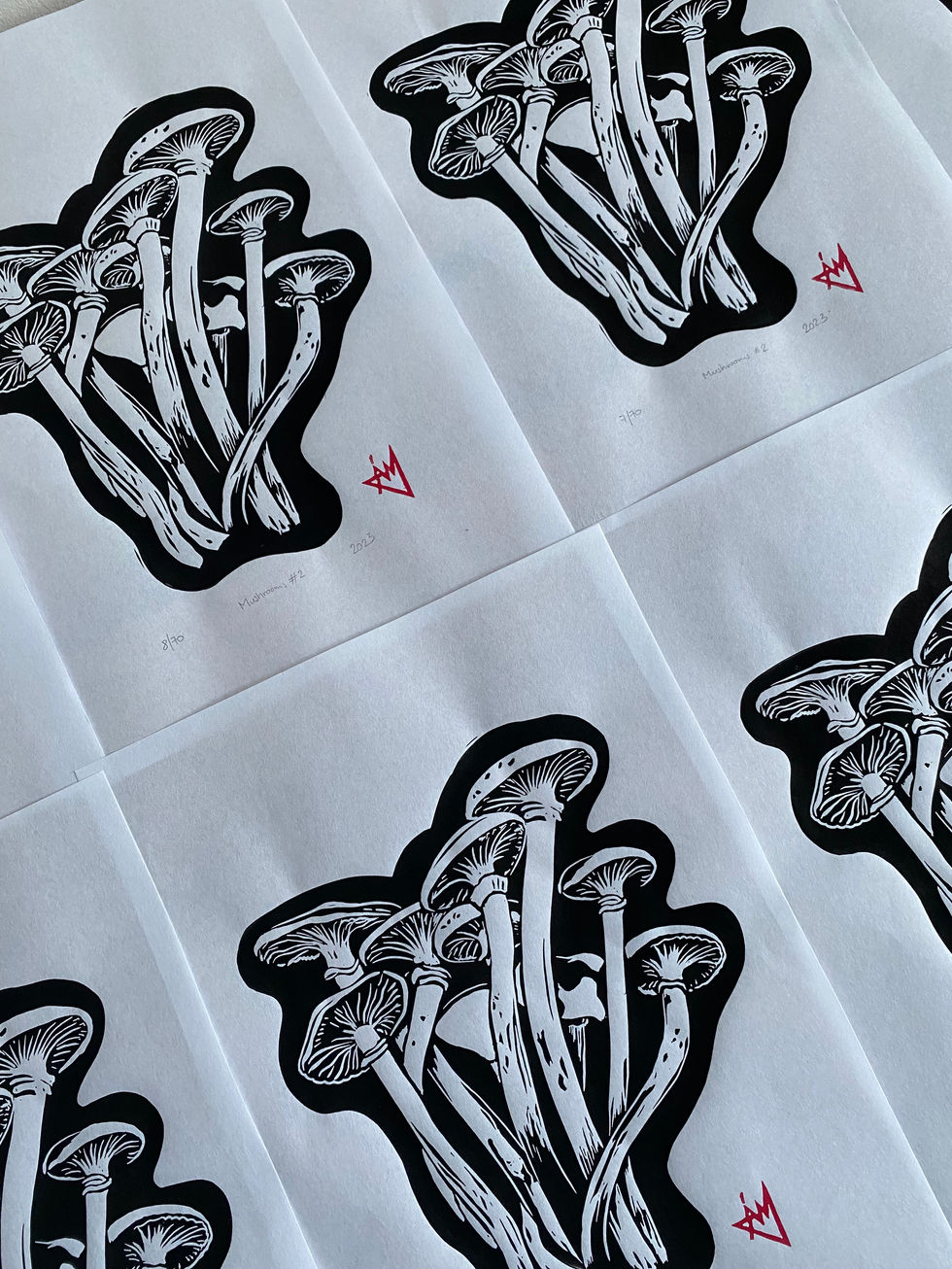 black linocut print of mushrooms