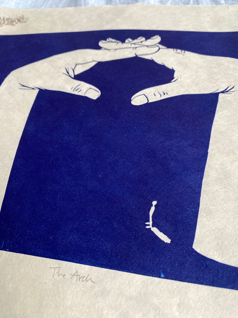 dark blue linocut print of two hands formed into an arch