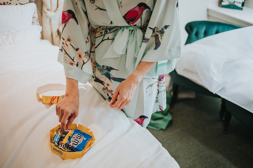 Bride eating sweets in her dressing gown before the wedding