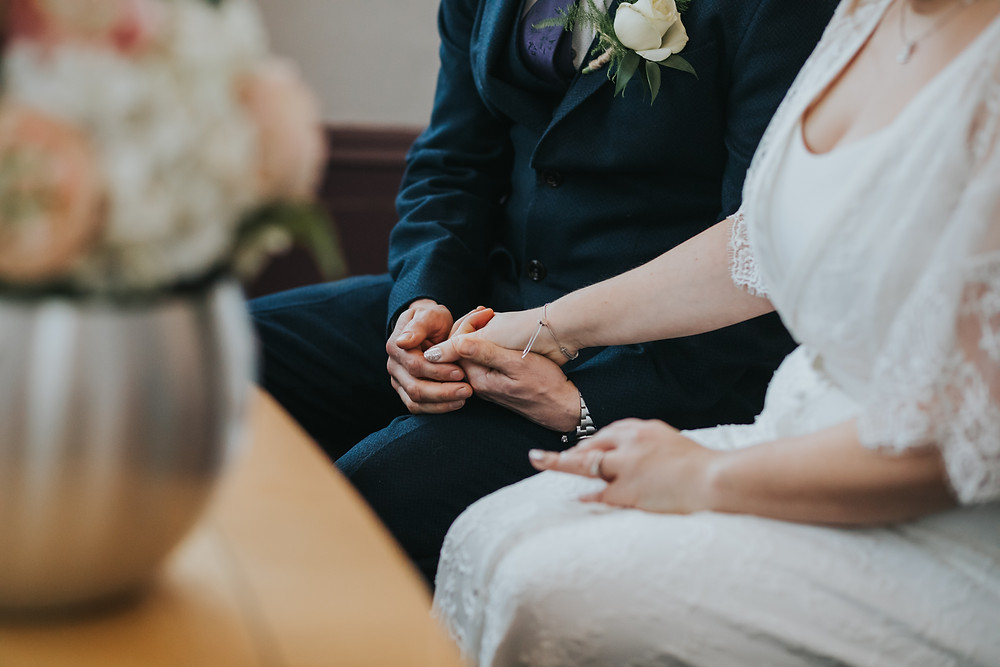 bride and groom holding hands