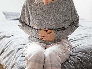 sick-woman-with-hands-stomach-suffering-from-intense-pain.jpg