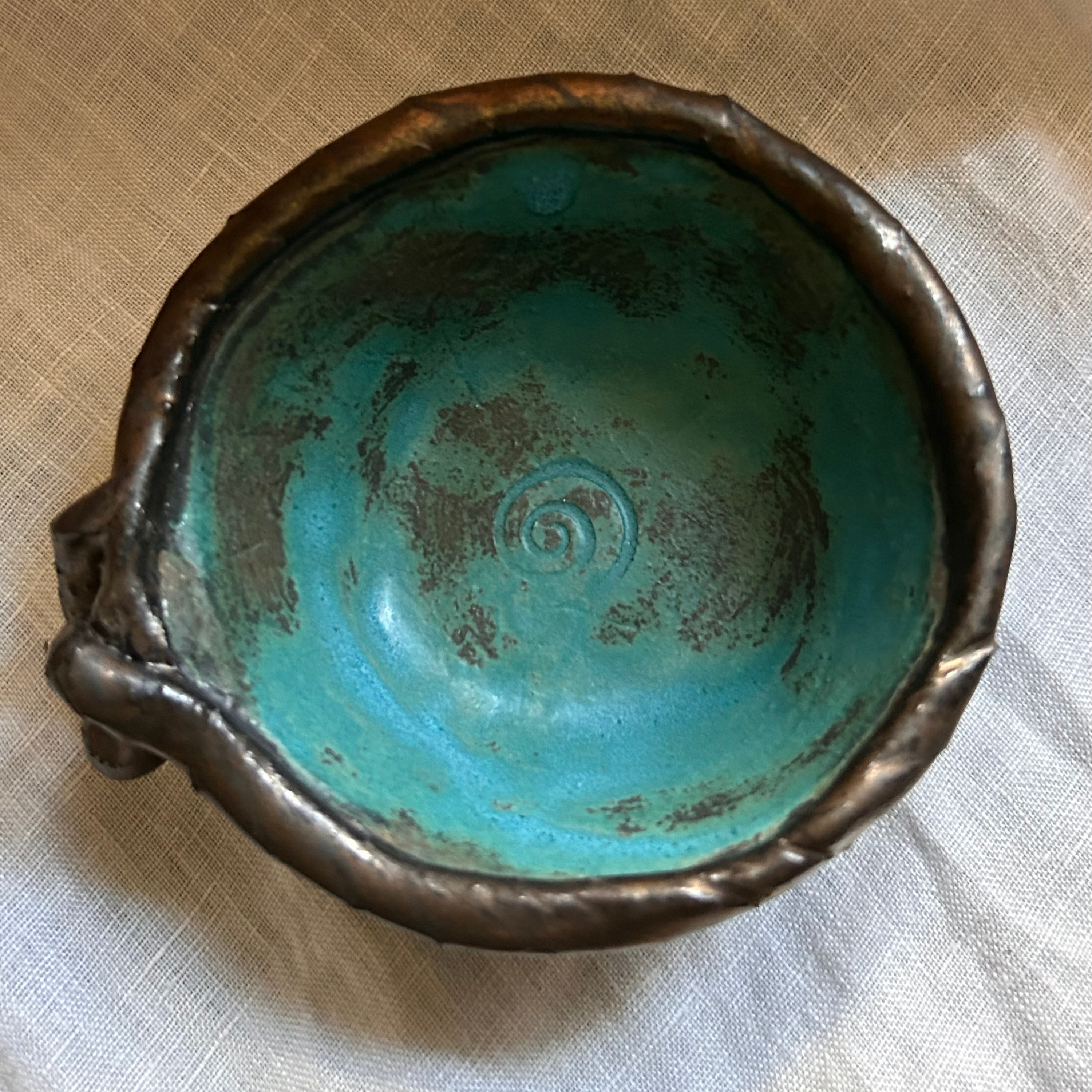 Handmade knotted small stoneware dish with green glaze, top view