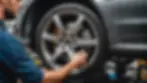 Eye-level view of a professional mechanic examining a Mercedes-Benz wheel
