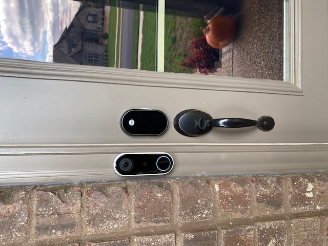 Floodlight security camera installed under a home's roof eave