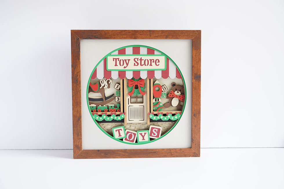 Brown framed 3d shadow box of a Christmas toy store