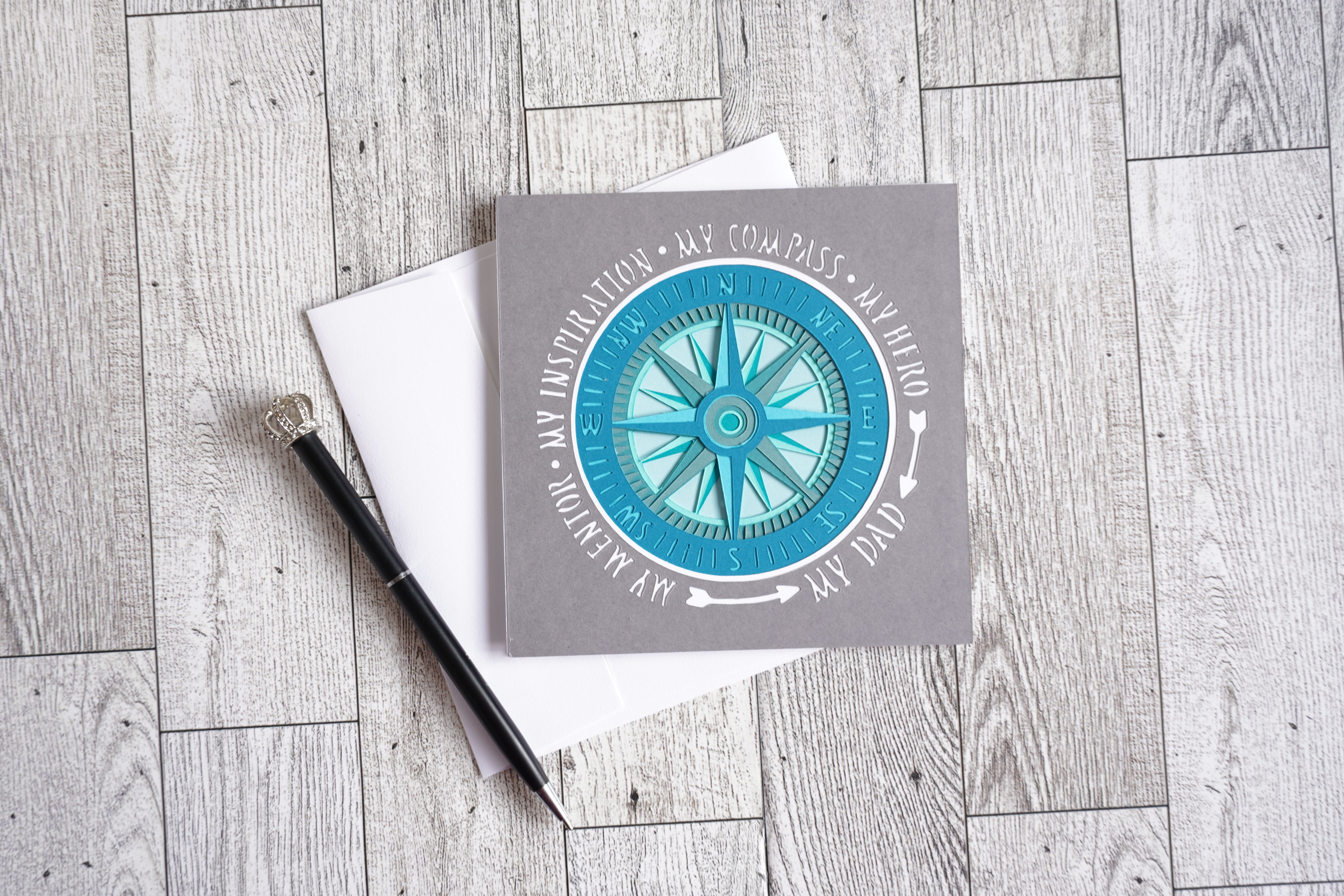 Gray and turquoise layered 5 x 5 card of a compass that celebrates dad for Father's Day