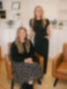 Photo of LKN Wellness nurse practitioners, Kelsey and Kate, smiling together in the beautifully decorated waiting room.