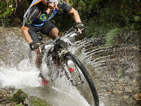 Riding a bike through a stream