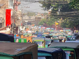 Street scene in Peshawar, Pakistan – green rickshaws lined up beneath a tangle of wires, capturing the vibrant stillness of everyday life in South Asia.