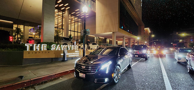 Chauffeured Luxury Sedan and Suv In front of the Kimpton Sawyer Hotel and the Golden One Center