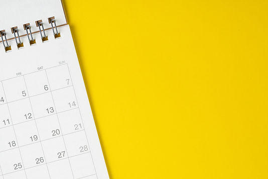 White clean calendar on solid yellow background with copy space, business meeting schedule