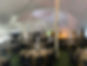 inside of rented tent set up with tables for event