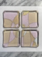 Set of four soft pink fused glass table art coasters titled Celebrate! One-of-a-kind. Varying pinks and iridescent.