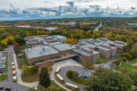 School with trees and parking lot