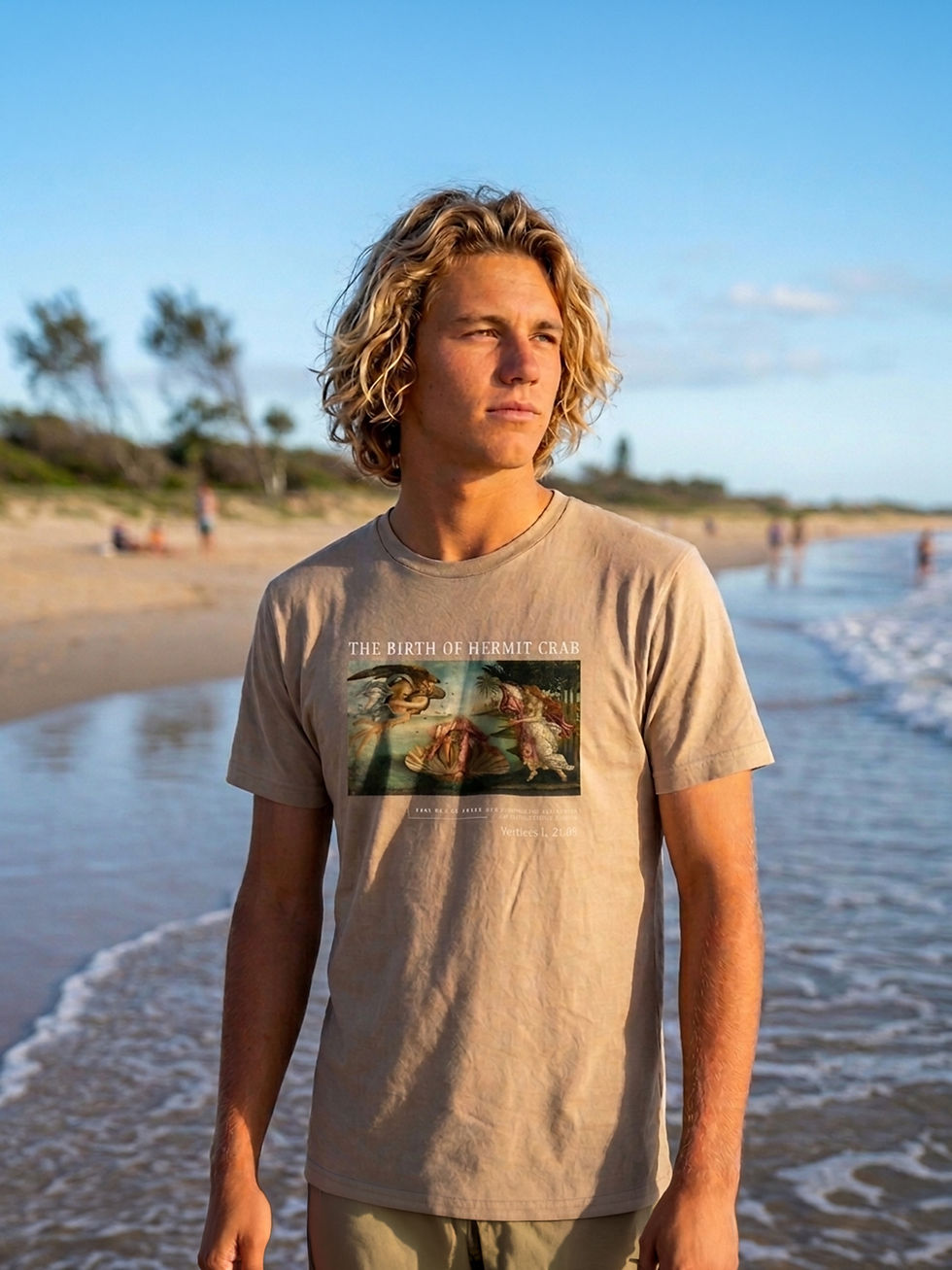Thumbnail: Tan hermit crab graphic tee worn by a surfer on the beach.