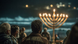 A crowd of people stands with their backs to the camera on a rainy night, facing a massive glowing golden Hanukkah menorah illuminated against a dark, stormy sky. The nine candles burn brightly, casting warm golden light across the faces of the gathered community. Rain falls gently, creating a misty, atmospheric glow around the menorah and the silhouetted figures, evoking unity, resilience, and the triumph of light over darkness during Chanukah.
