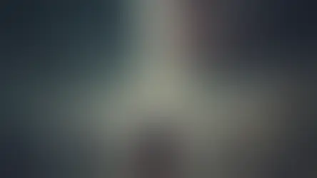 A dramatic, apocalyptic political scene: Donald Trump stands resolute at a wooden podium under a stormy sky, lightning striking directly behind him as a massive, tattered American flag waves in the wind. The U.S. Capitol looms in the distance. To the left, a border fence and anxious immigrant families; to the right, overflowing grocery aisles with skyrocketing prices and frustrated shoppers. Debris litters the ground, symbolizing the high-stakes tension one year before the 2026 midterms. Cinematic, intense, and symbolic.