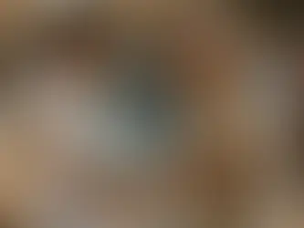 In the warm golden light of a Jerusalem afternoon, a young bearded Chabadnik in a black hat and white shirt joyfully shakes hands with an older non-Jewish man wearing a white kippah, handing him a colorful card about the Seven Noahide Laws. Both men are beaming with mutual warmth and respect on a bustling stone-paved street, with a tefillin stand and stacks of brochures visible in the foreground and softly blurred passersby in the background. A moment of heartfelt connection and solidarity.