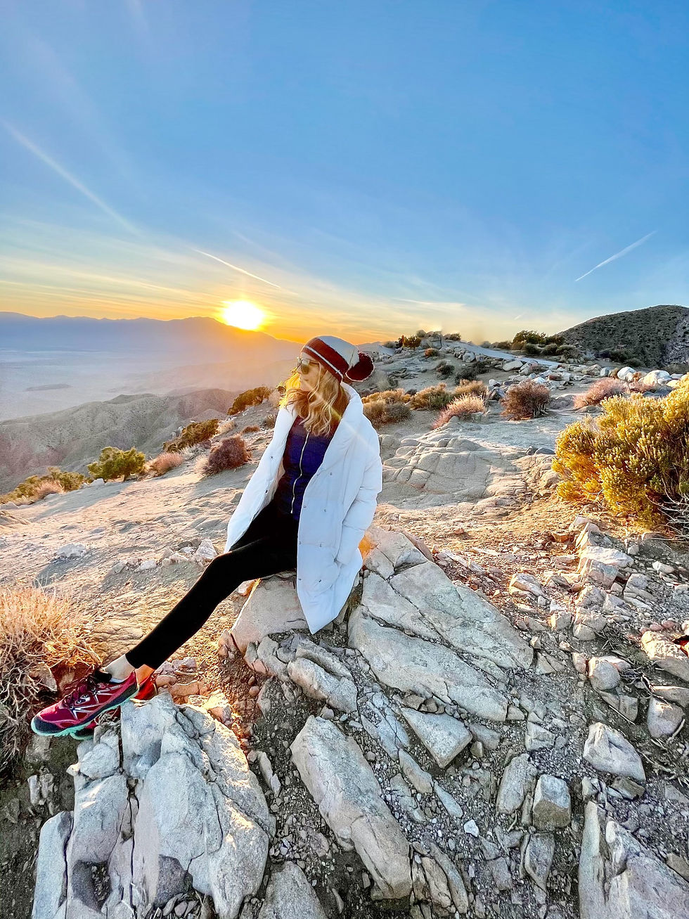 Woman hiking in the desert at sunset
