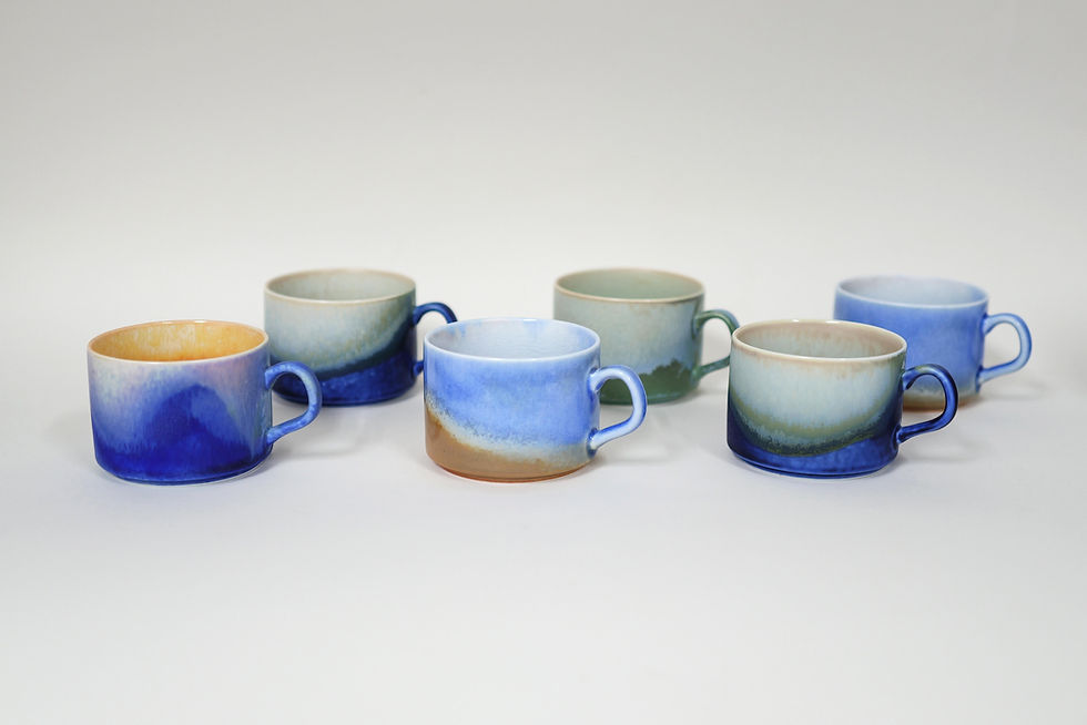 Thumbnail: Flambe ceramic mugs in varied blue and green glazes displayed together
