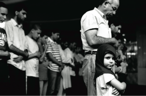 “Young Girl Praying with Her Father,” Muslim American Society, Brooklyn, NY, 2010. All Images © Robert Gerhardt. Gerhardt created this photo series to “encourage a dialogue between Muslims and non-Muslims in America that attempts to erase the boundaries that engender a sense of ‘them’ and begin to foster a sense of ‘us.’”
