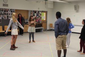 Ms. Speed, an enthusiatic theater teacher, leading her class in the acting routine “take the stage”.