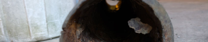 Hollowed-out log with interior visible, also a pail in background. a p a r inc home ins.