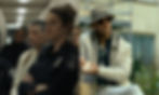 Shailene Woodley in a cop uniform, Michael Fassbender sitting and holding a burger