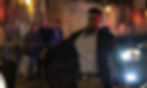Chadwick Boseman flashing a badge on his belt