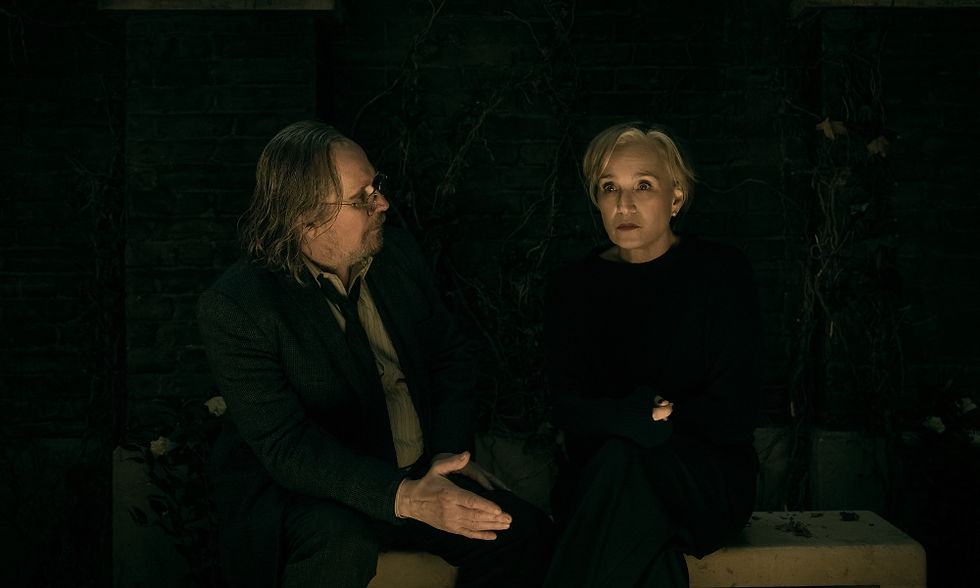 Gary Oldman and Kristin Scott Thomas having a wee ol' chat on a bench in a backyard.