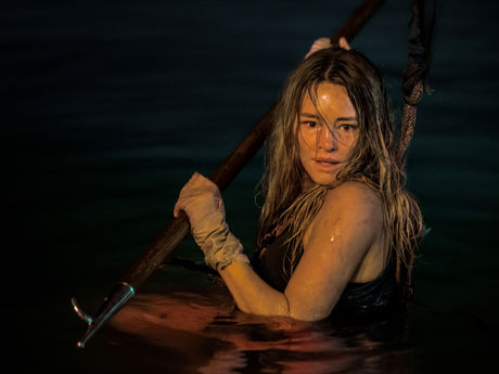 Hassie Harrison rocking a harpoon in the water.