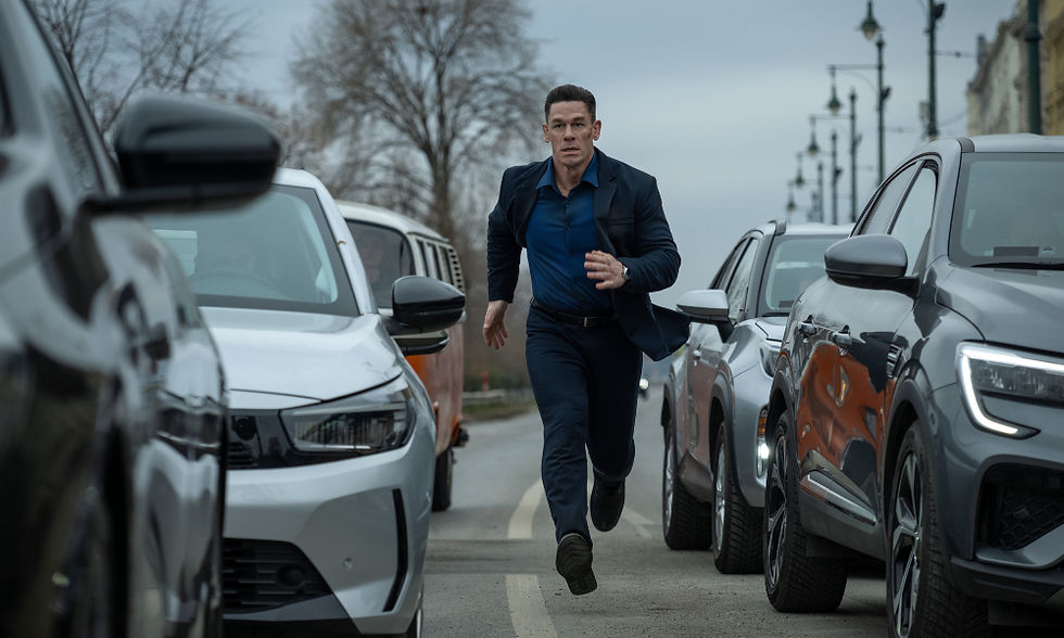 John Cena running in between cars stuck in traffic.