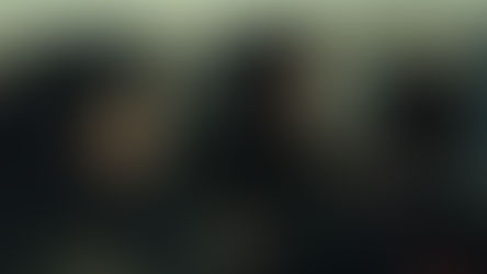 Gerard Butler grabbing Roman Griffin Davis's face affectionately next to a cliff whilst Morena Baccarin grabs Butler's arm.