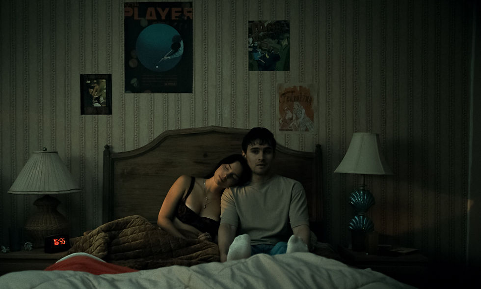 Inde Navarrette resting her on Michael Johnston's shoulder in bed, with posters on the wall above them.