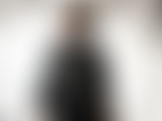 Sydney Chandler inside a spaceship, standing in front of blinding white light.