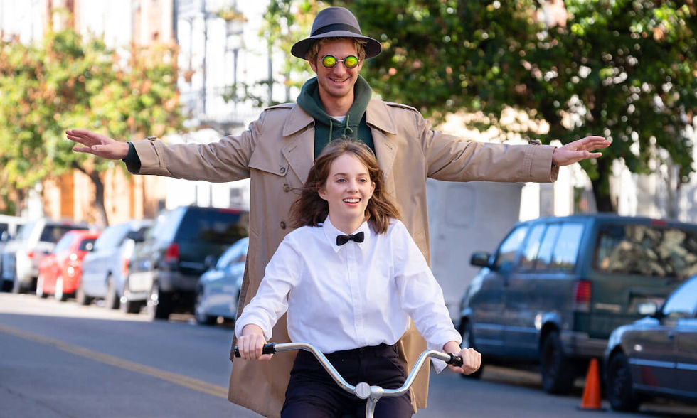 Maya Hawke and Andrew Garfield both on the same bike