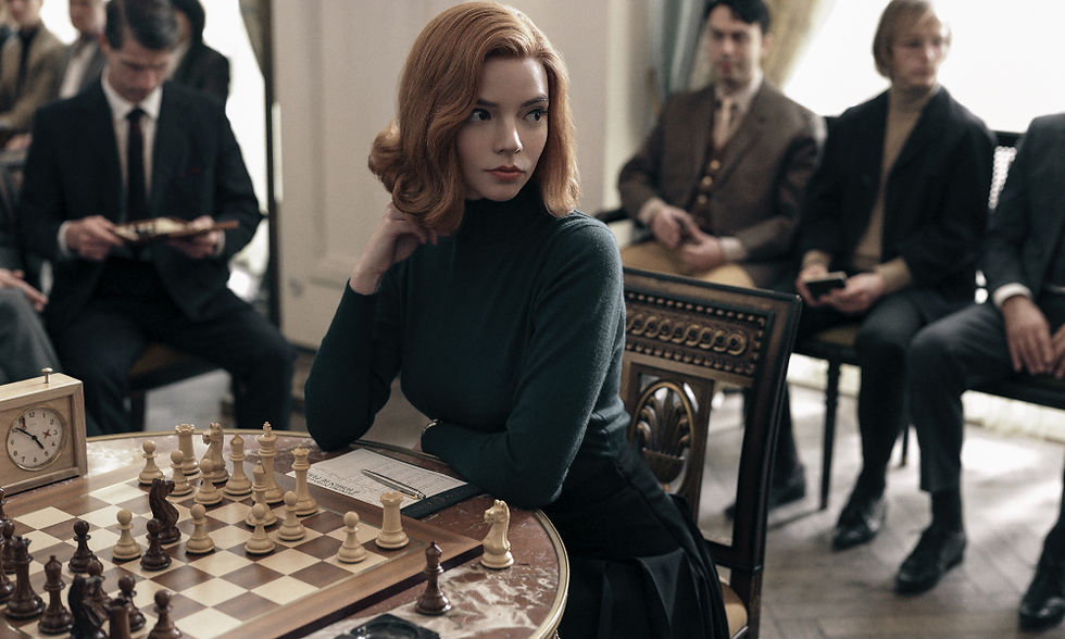 Anya Taylor-Joy sitting down, playing chess