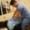 Doctor performs a chiropractic adjustment on a patient lying face down in a treatment room