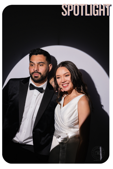 A couple posing for a spotlight photo booth