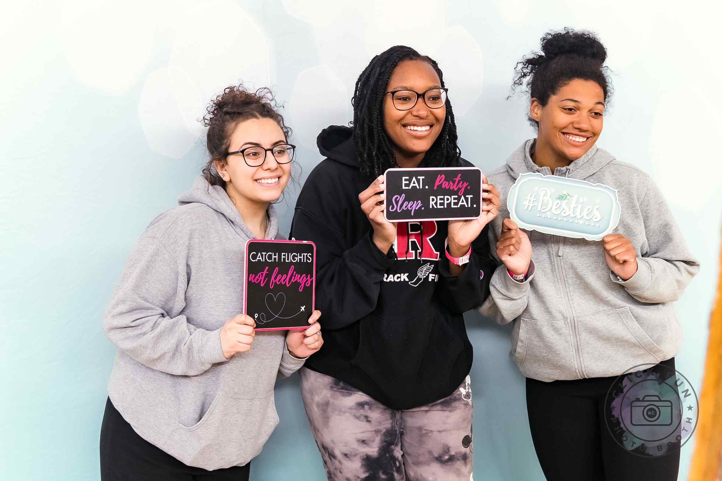 Three women posing for a photo booth