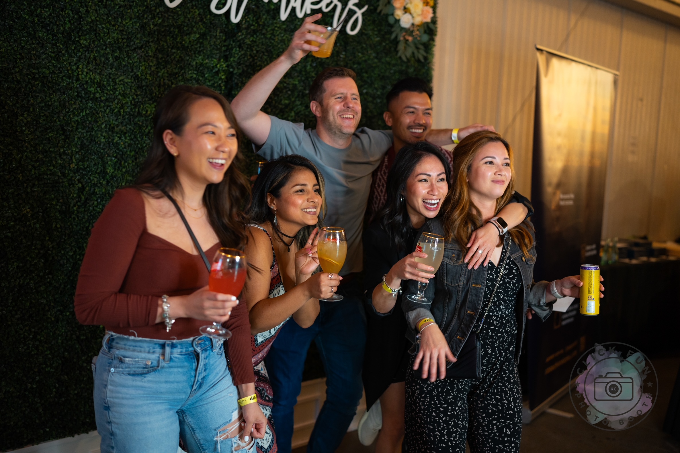 People enjoying a photo booth having a great time while posing