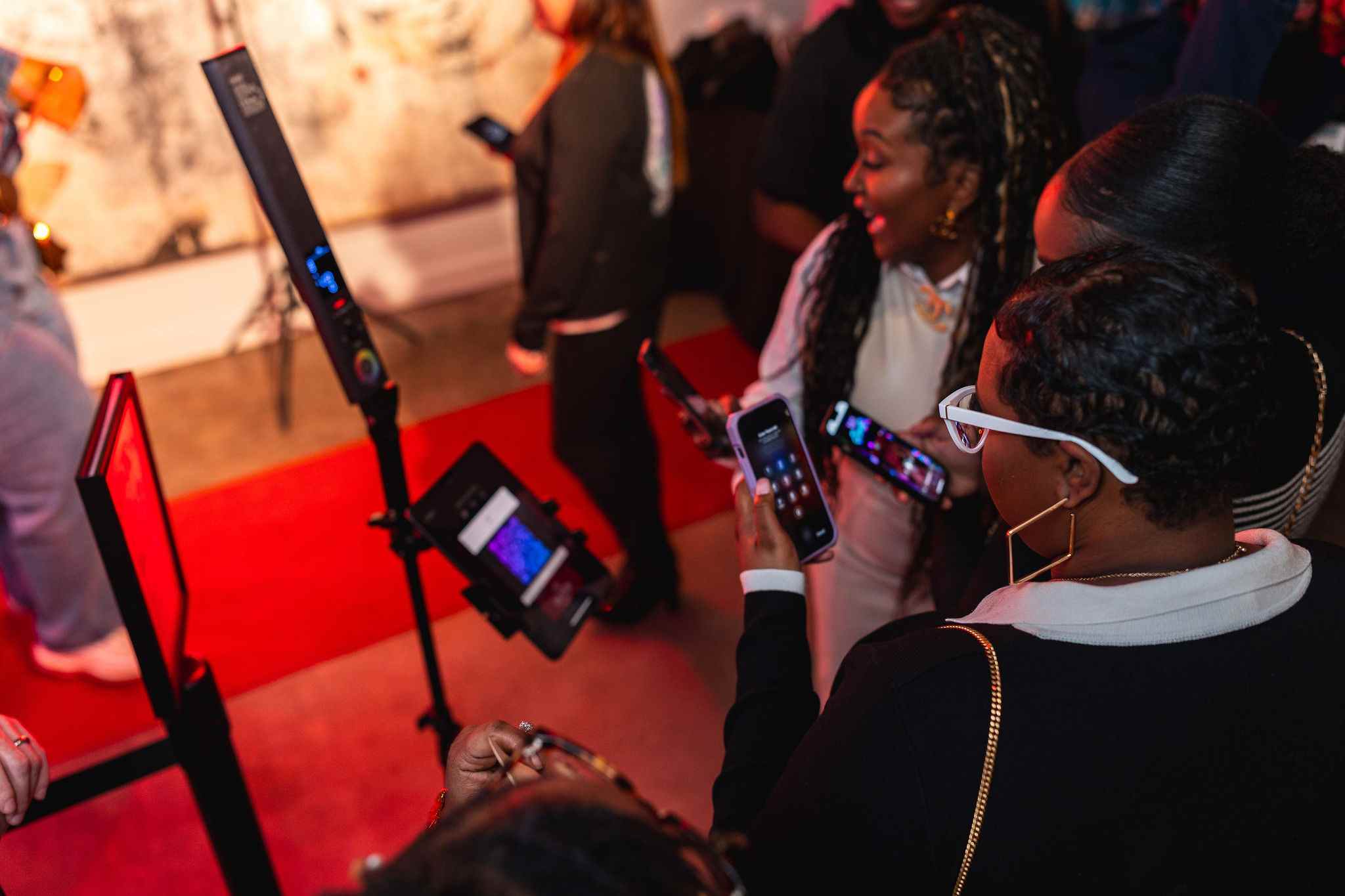 People reacting and smiling after seeing their photo booth photos