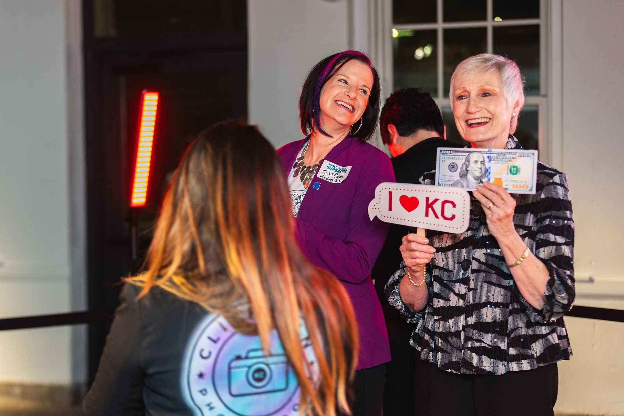 Two women posing in a 360 photo booth by click fun photo booth.