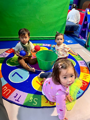 3 children playing with toys during circle time
