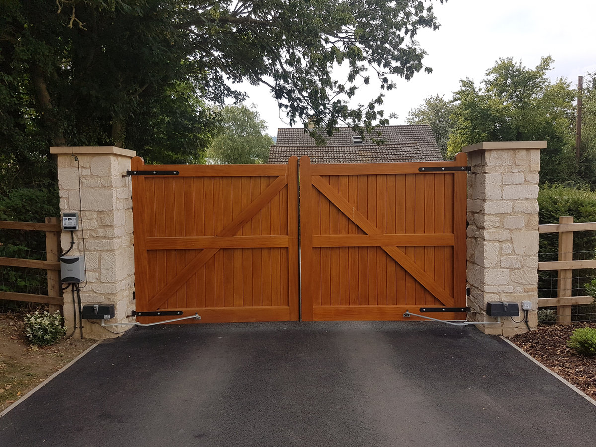 Gate control panel and safety photocells fitted at a hardwood gate entrance