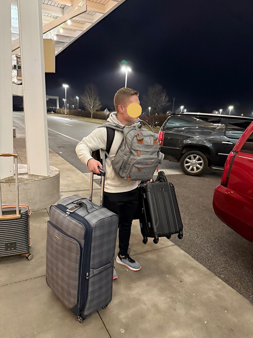 My brother in law carrying their bags so that my sister can carry my nephew